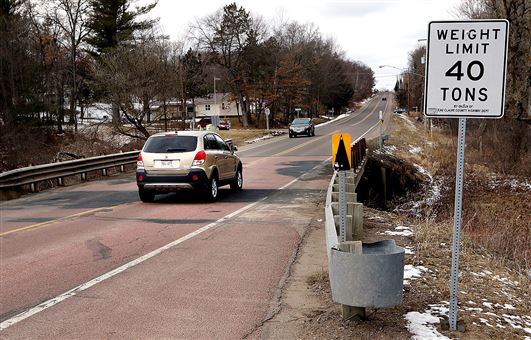 Traffic crosses a bridge over Otter Creek Thursday on heavily traveled Prill Road near the southeast city limits of Eau Claire. The road, which connects with the Oakwood Mall area, has been identified as one of the Eau Claire County roadways most in need of reconstruction.  Photo credit: Steve Kinderman 