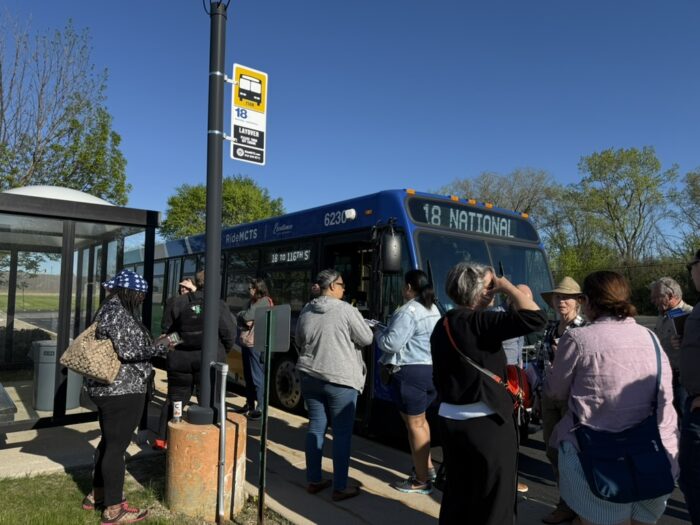 People boarding the bus, which reads "18 National"