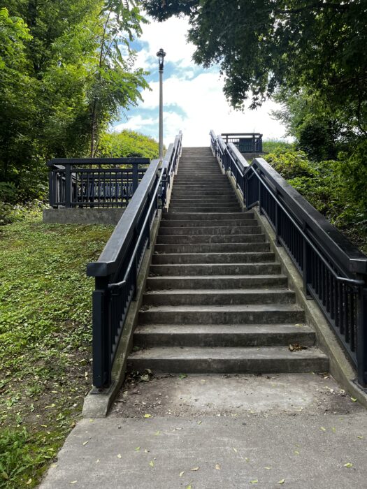 Image shows a staircase leading up to a public park