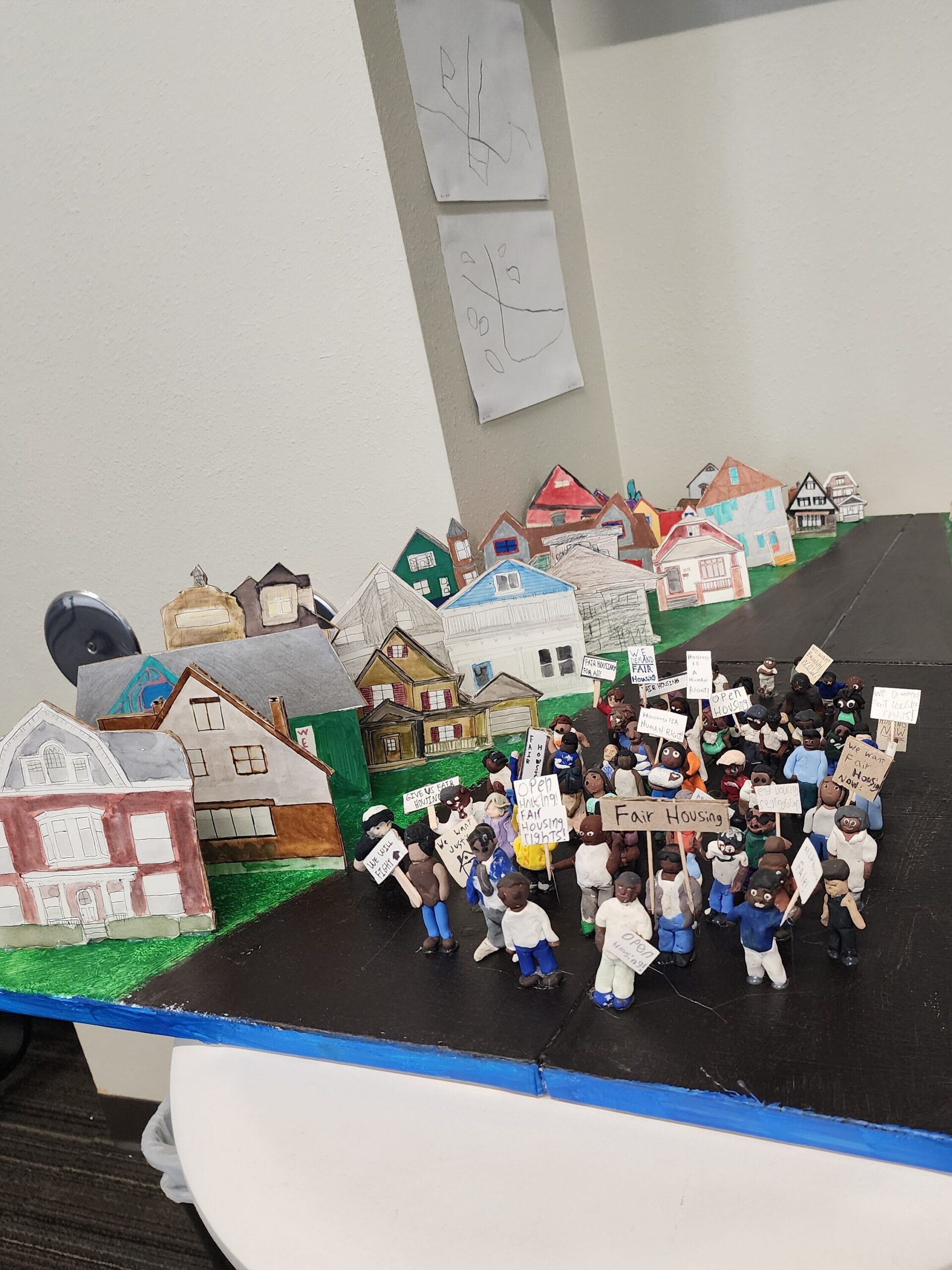 Fair Housing claymation model on table with people and houses, part the NextGen Housing Tour and Community Development Alliance in Milwaukee, Wisconsin