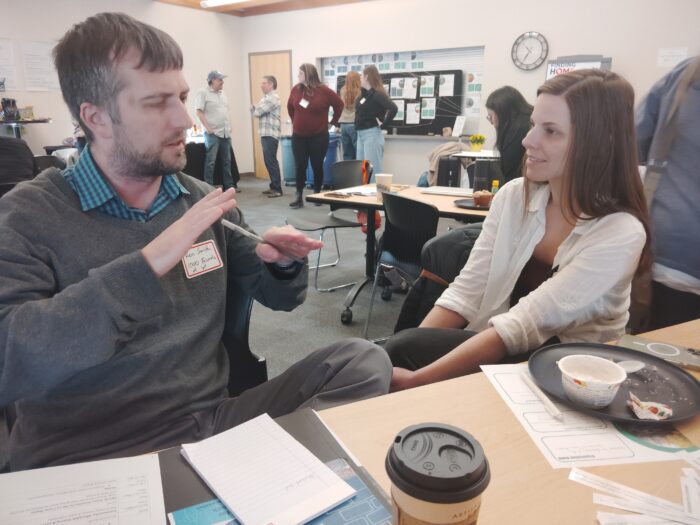 Ken Smith of Housing Onward discussing sustainable housing ideas with Habitat for Humanity of La Crosse
