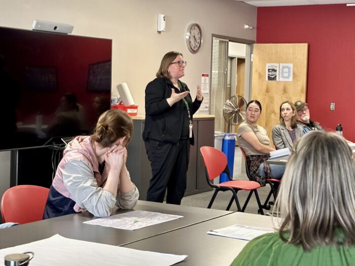 Participants in the Madison Community Transportation Academy discuss maps and transportation goals.
