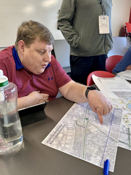 Participants in the Madison Community Transportation Academy discuss maps and transportation goals.