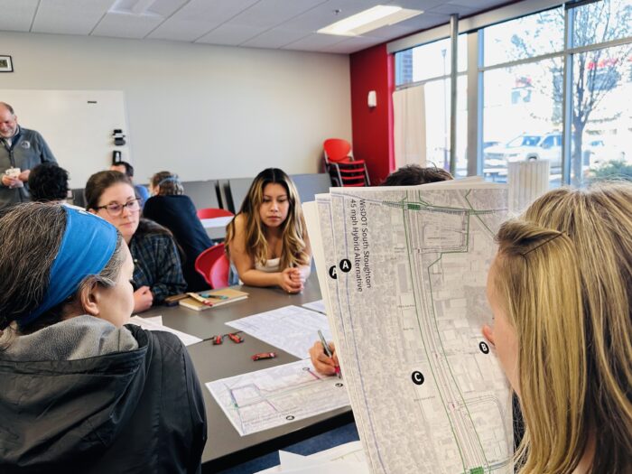 Participants in the Madison Community Transportation Academy discuss maps and transportation goals.