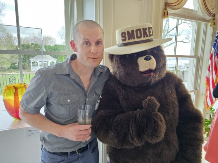 Trevor Roark poses with Smokey the Bear mascot
