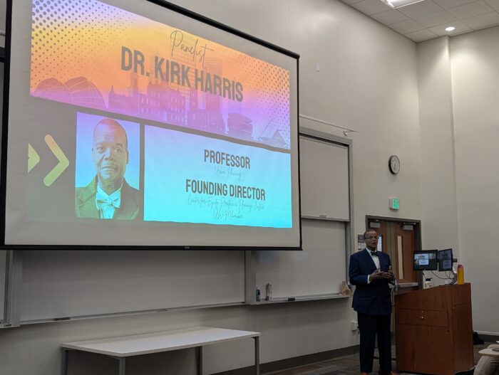 Dr. Kirk Harris speaking. Community Land Trust topic discussed at Marquette University in Milwaukee