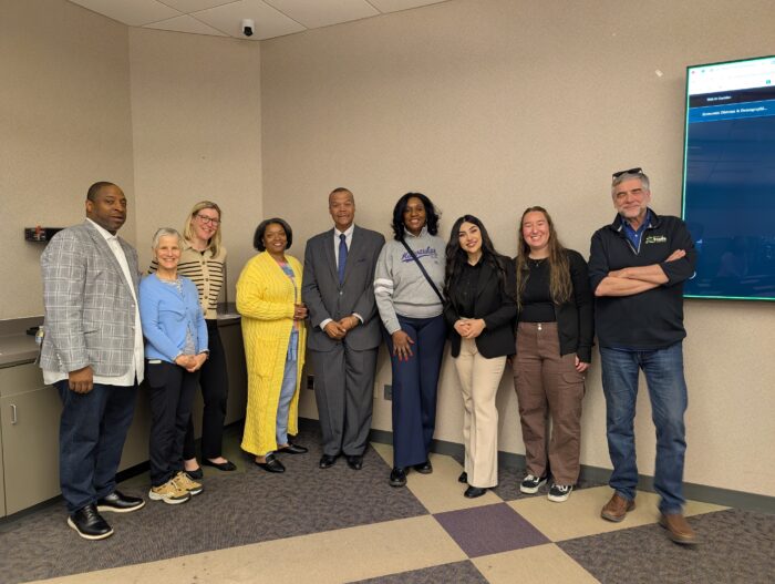 Group photo showing students Darya Salehi and Kelli Beine, Dr. Kirk Harris, Representatives of the BID #37, City of Milwaukee officials, and community members gathered together after the May 14 meeting.