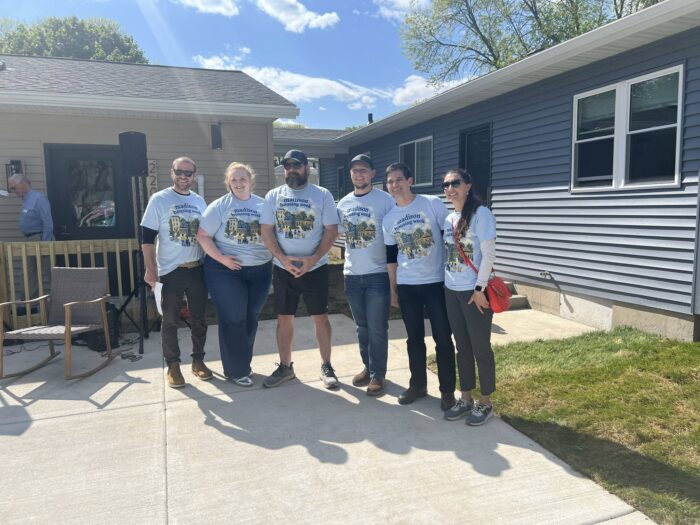 group photo of Madison Housing week participants posing in front of newly-constructed accessible ADUs in Madison, Wisconsin