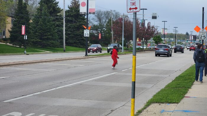 Pedestrian attempts to cross a busy stroad intersection